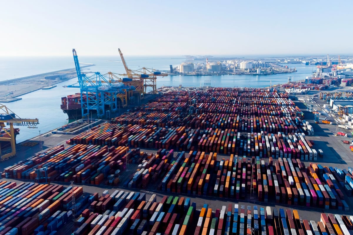 Aerial view of shipping containers and cargo ships in the sea port of Barcelona in Spain, Europe. Concept of sea and maritime trade and commercial hub